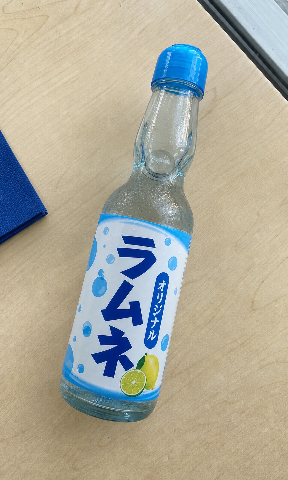 Photo of a Japanese ramune soda bottle with a label written in Japanese